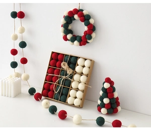 Detail of red, white and green wool felt balls in a kraft gift box for Christmas