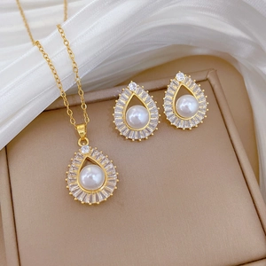 Macro shot of palace style gold drop pearl necklace and earrings set in a jewelry box