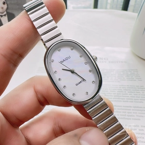 Detailed close-up of oval mother-of-pearl dial with diamond markers and silver strap