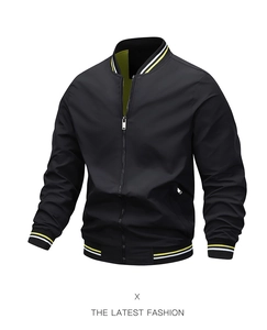 Detail view of black bomber jacket with bright yellow lining and striped ribbed collar
