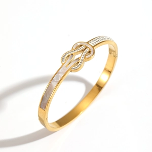 18K gold-plated stainless steel bangle featuring an infinity knot with shell inlay and zircons