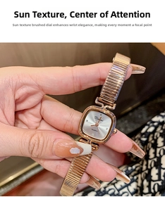 Detail of square rose gold quartz watch with sunray dial and metal link bracelet