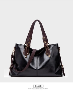 Black leather commuting shoulder handbag, spacious daily tote bag with contrast straps.