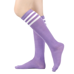 Detail of purple calf high socks with three white stripes made of soft knitted cotton
