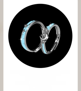 Detail of star and moon couple rings with light blue enamel and sparkling zircon inlay