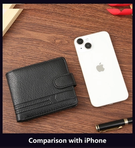 Men's black PU leather wallet with snap closure next to a phone for size comparison