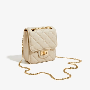 Beige quilted crossbody bag with gold chain strap and elegant metallic twist lock