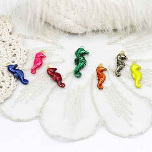 Macro detail of colorful sea horse charms with drip oil finish and delicate metal texture