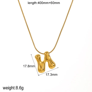 Detail of 18k gold plated H-letter pendant necklace with liquid metal texture design