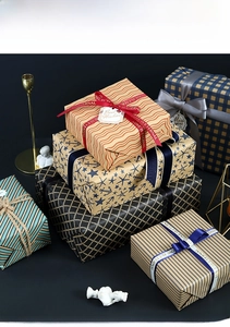 Neutral plaid gift wrapping paper set with ribbons and tags for men's holiday gifts