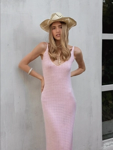 Close-up of pink crochet knit dress featuring intricate hollow-out texture and stitching
