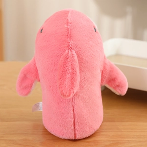 Close-up of pink plush shark puppet showing soft texture and detailed stitching on wood