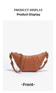 Front view of a brown hand-woven crescent bag with silver zipper and knot strap detail
