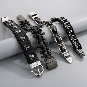 Detailed close-up of retro punk leather bracelets featuring skull and tiger head designs
