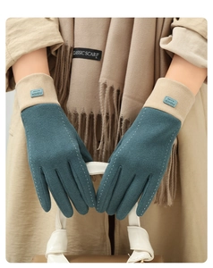 Close-up of dark green and beige suede gloves with warm fleece lining and touch screen tips