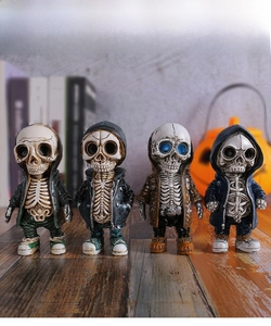 Four creative street style skeleton figurines in hoodies on a wooden display table