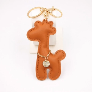 Detail of brown PU leather giraffe keychain with gold ring and sparkling stone pendant