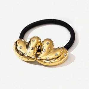 Black elastic hair tie with dual gold heart charms encrusted with shimmering crystals
