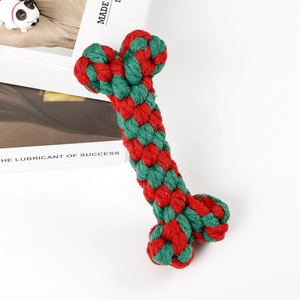 Close-up of red and green bone-shaped cotton rope dog toy on a white background