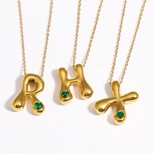 Polished 18k gold plated bubble letter necklaces with green heart-shaped gemstones