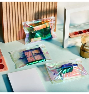 Detailed view of holographic EVA zipper bags for cosmetics on a blue background