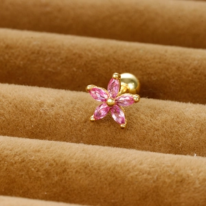 Macro shot of pink zircon flower stud earrings with a gold-plated screw back closure
