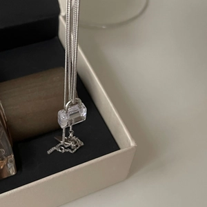 Detail of 925 sterling silver necklace featuring a mini cubic zirconia padlock pendant