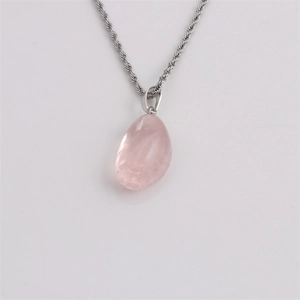 Handmade necklace with irregular pink natural quartz crystal pendant on silver twisted chain