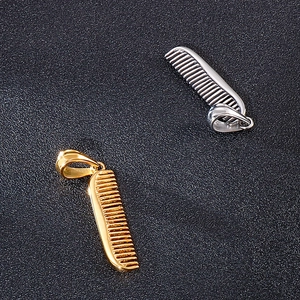 Close-up of hip-hop comb pendants in gold and silver finish on a dark background
