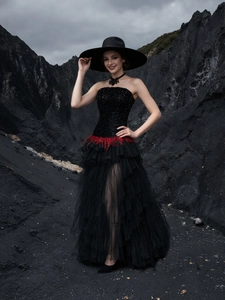 Elegant black sequin strapless evening gown with red feathers and layered mesh skirt