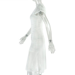 Detail of white pleated bodycon dress featuring elegant shoulder cape and ruched texture