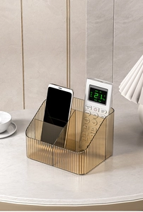 Detail view of transparent brown acrylic desk organizer with two compartments on marble desk