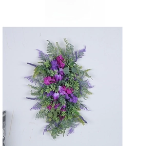 Vertical wall display showing lifelike purple tulips and mixed silk flowers with greenery