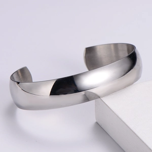 Detailed view of wide silver Mobius cuff bracelet with polished mirror surface