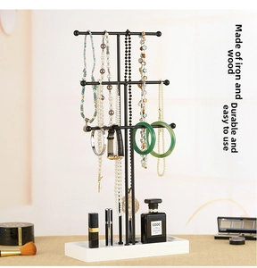 Three-tier black metal jewelry stand with white base for necklaces and watches