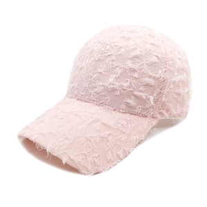 Detail of light pink baseball cap featuring unique feathered fringe texture and classic 6-panel design