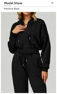 Detail of premium black zip-up hoodie featuring ribbed hem and metallic drawstring tips