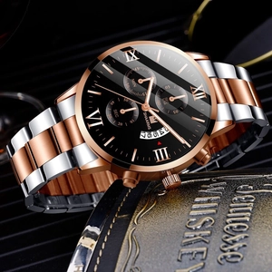Macro view of bicolor stainless steel watch band and black dial with Roman numerals