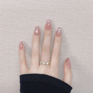 Pink cat eye press-on nails with 3D silver lines, pearls, and a gold heart ring