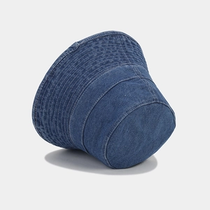 Detail of deep blue denim bucket hat featuring contrast white multi-row stitching