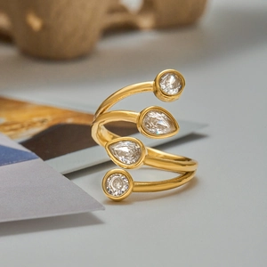 Elegant gold spiral titanium steel ring featuring four sparkling cubic zirconia stones