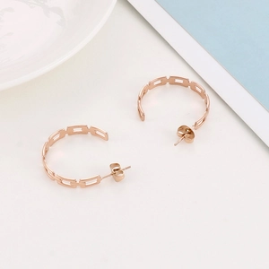 Detailed macro view of rose gold chain-link style half-hoop earrings in stainless steel