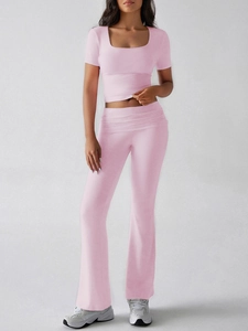 Pink Y2K two-piece set featuring short sleeve crop top and high waist flared trousers
