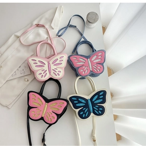 Detail view of four butterfly-shaped PU leather crossbody bags with glitter wing accents