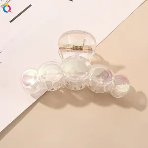 Macro view of transparent laser bubble hair claw clip with colorful iridescent finish