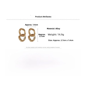 Detail view of gold geometric chain earrings with 2.7cm size and 14.9g weight specifications