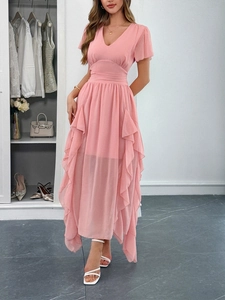 Detailed view of pink chiffon v-neck dress featuring layered ruffle hem and high waist line