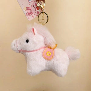 Dettaglio del portachiavi a forma di cavallo di peluche rosa con chiusura dorata