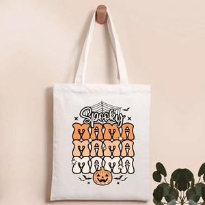 Detail of Spooky MAMA Halloween print on beige canvas tote bag with pumpkin and bats