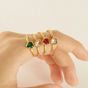 Set of gold heart-shaped zircon rings with green, white, red, and pink gemstones